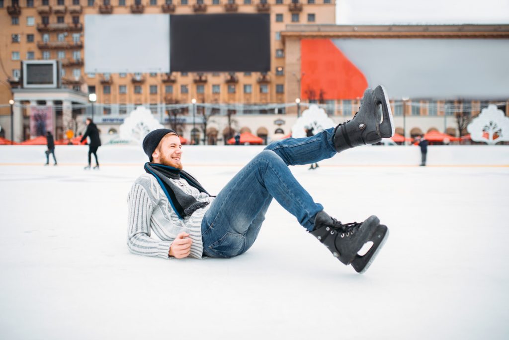 A guy smiling out of joy, as he enjoys the outdoor skating rink in the Poconos