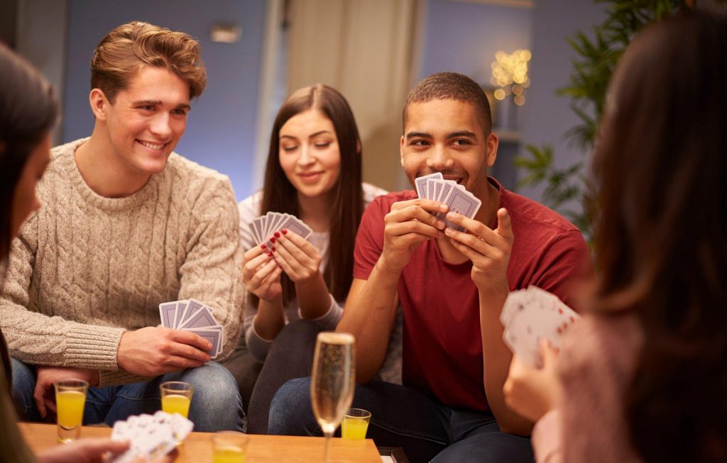 A group of teens enjoying a game of cards on their prom
