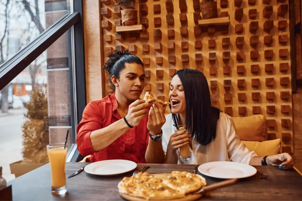 Couple enjoying a pizza at a cozy restaurant in Lake Harmony