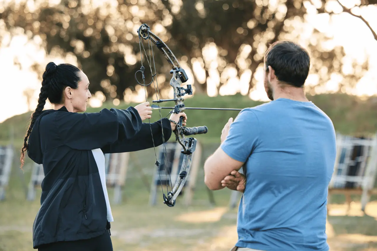 Archery instructor and female target practice in poconos
