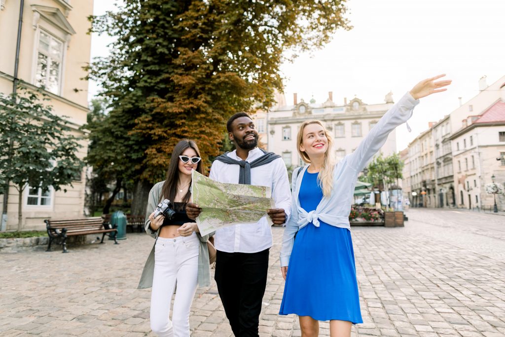 3 tourists with a map in their hand walking around the Poconos