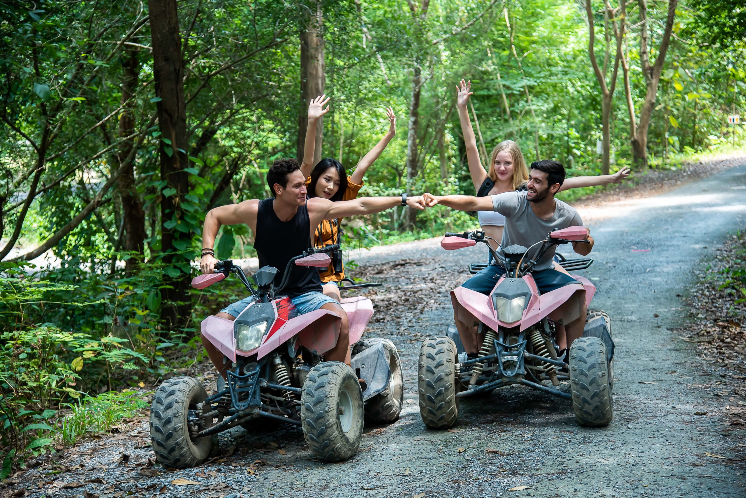 Guys enjoying an ATV riding through the lush forest trail in the Poconos